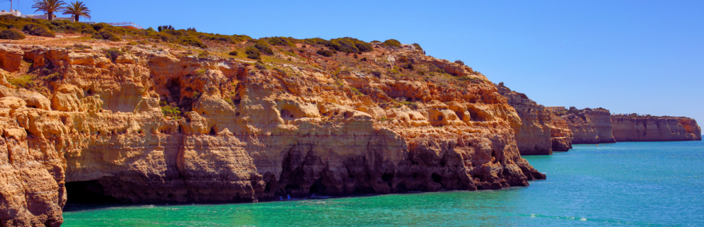 Coast with beige cliff at blue ocean