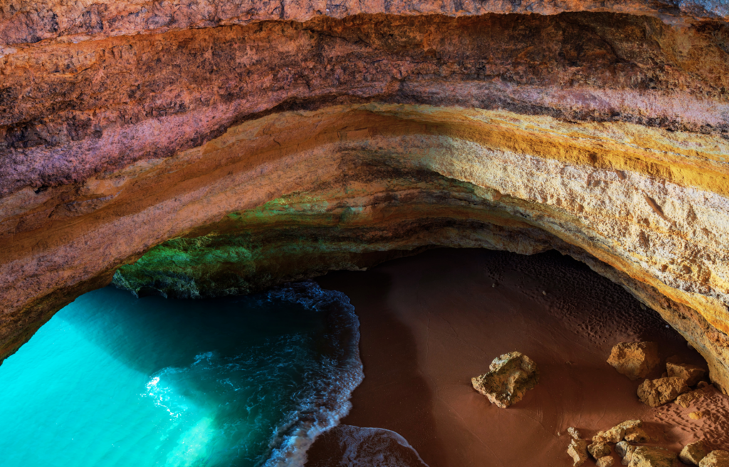 A coastal cave with rock walls and ocean