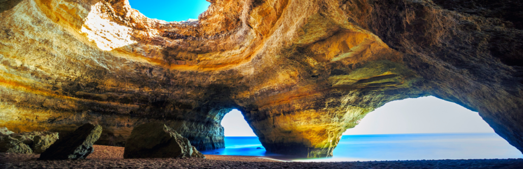 Inside a cave with rock walls and sky opening