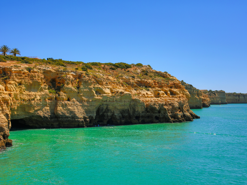 Coast with beige cliff at blue ocean